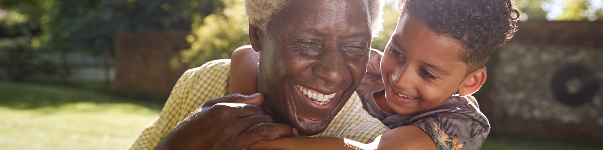 boy hugging his smiling grandpa 