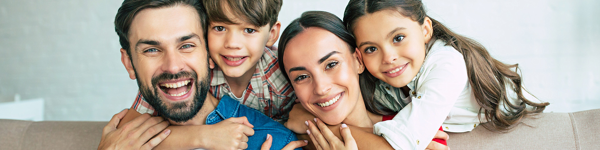 girl and boy hugging their mother and father 